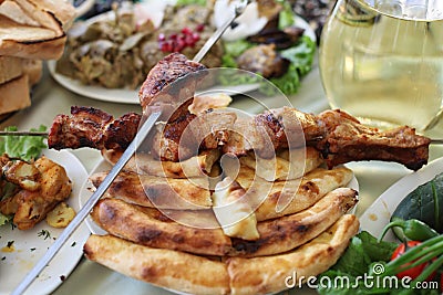 Dish with roasted young pig and vegetable salad. Food table background Stock Photo