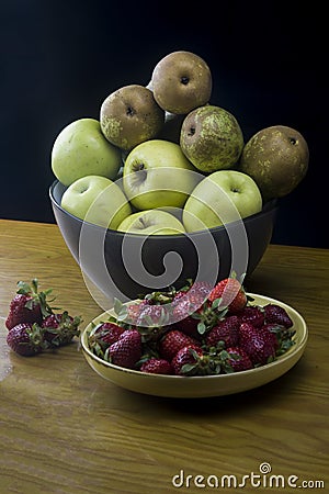 Dish with strawberries and bowl with fresh fruits Stock Photo