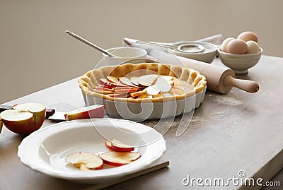 Dish with uncooked apple pie on table Stock Photo