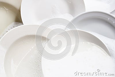 Dish washing, dishes soaking in kitchen sink Stock Photo