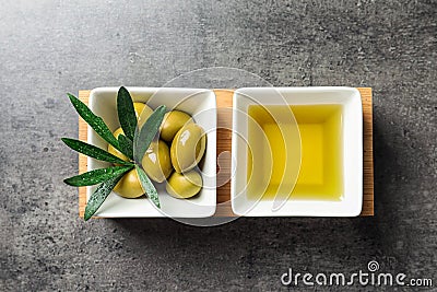 Dishes with olive oil and ripe olives on table Stock Photo