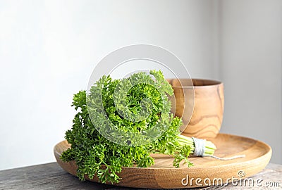 Dishware and fresh green parsley Stock Photo