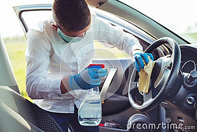 Disinfecting inside car, wipe clean surfaces that are frequently touched, prevent infection. Stock Photo