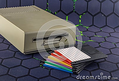 Disk drive from an old computer, colorful 3.5-inch floppy disks Stock Photo