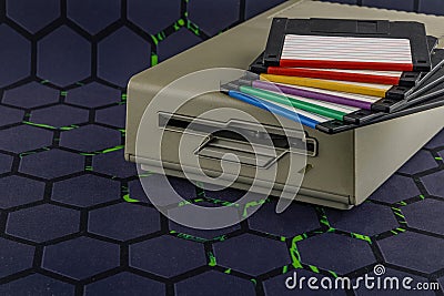 Disk drive from an old computer, colorful 3.5-inch floppy disks Stock Photo