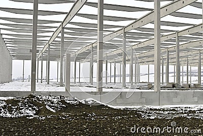 A dismantled plant hall in winter. Building site during winter. The concept of the end of the building season and the end of Stock Photo