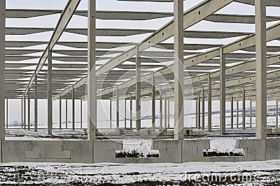 A dismantled plant hall in winter. Building site during winter. The concept of the end of the building season and the end of Stock Photo