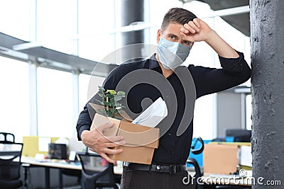 Dismissal employee in an epidemic coronavirus. Dismissed worker going from the office with his office supplies Stock Photo