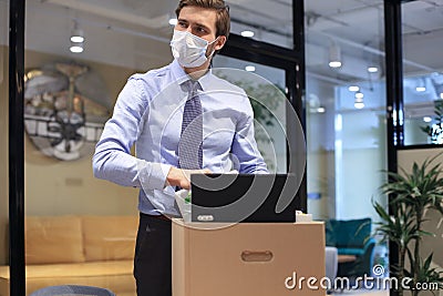 Dismissal employee in preventive medical mask in an epidemic coronavirus Stock Photo