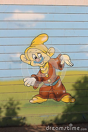 Disney cartoon character Dopey dwarf, mural on the fence. iranian street art. Shiraz, Iran Editorial Stock Photo