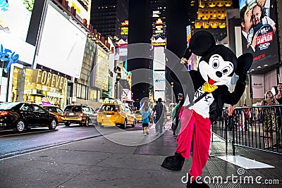 Times Square, New York City, New York, United States - circa 2012 disney mickey mouse character in costume times square at night Editorial Stock Photo