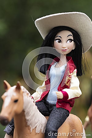 Disney princess doll Mulan walking on a horse Editorial Stock Photo