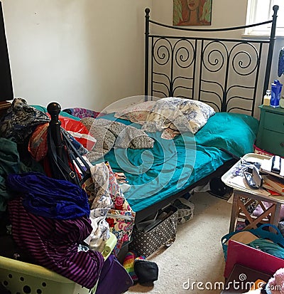 Disorganized bedroom filled with clutter. Stock Photo