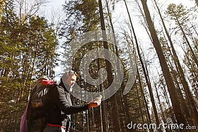 Disoriented hiker checking her phone for direction Stock Photo