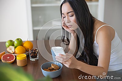 Serious young lady sitting at the table Stock Photo