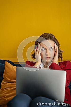 Dispirited modern young business lady looking away Stock Photo