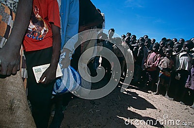 Displace people queue for aid in a camp in Angola Editorial Stock Photo