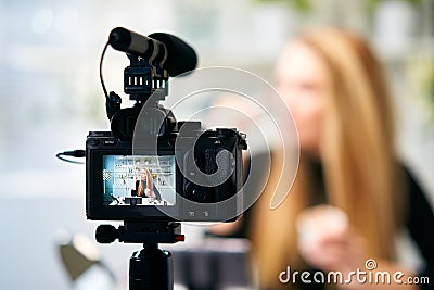 Display of camera recording video blog for blonde beauty blogger woman with make-up at home studio. Influencer vlogger Stock Photo