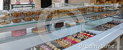 A display of French pastries and baked goods including a variety of donuts, coffee rolls, and muffins Stock Photo