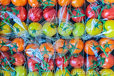 Display of fresh plastic wrapped cherry tomatoes Stock Photo