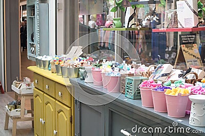 Display of scented soaps at a market vendor stall in indoor shopping area Editorial Stock Photo