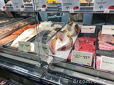 A display of a variety of fish in a refrigerated case at a grocery store Editorial Stock Photo