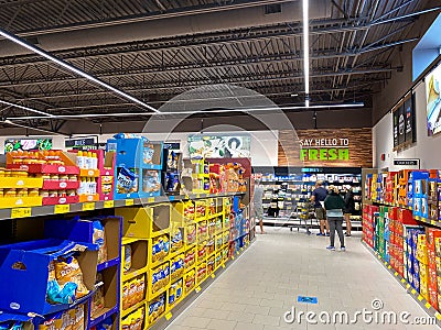 A display of a variety of potato chips and cookies at an Aldi grocery store Editorial Stock Photo