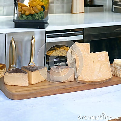 Display of various types of cheese on the kitchen table- Stock Photo