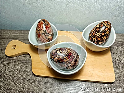 display of wooden craft eggs on the table with Indonesian batik motifs Stock Photo