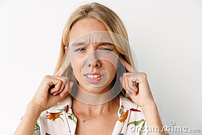 Displeased beautiful girl plugging her ears while posing at camera Stock Photo