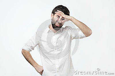 Displeased brunet male plugs nose as smells something stink and unpleasant. Stock Photo