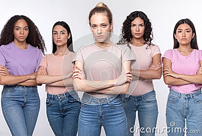 Displeased Mixed Women Standing Crossing Hands Over White Background Stock Photo