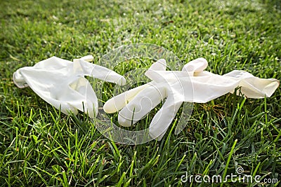 Disposable anti Coronavirus gloves thrown on the ground Stock Photo