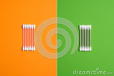 Disposable Bamboo Double-head Cotton Swabs Wood Sticks Buds Ears Cleaning Tool vs Plastic Ear Sticks. Comparison concept. No Stock Photo