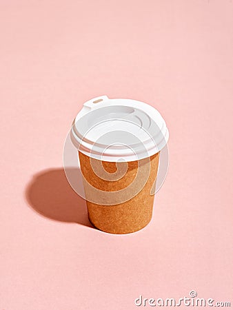 Disposable coffee cup on pink background. Stock Photo