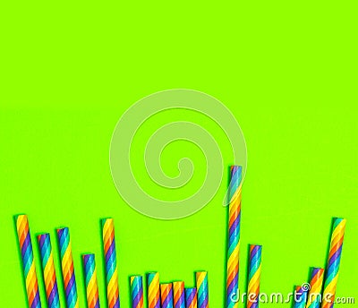 Disposable colorful paper straws on green background Stock Photo