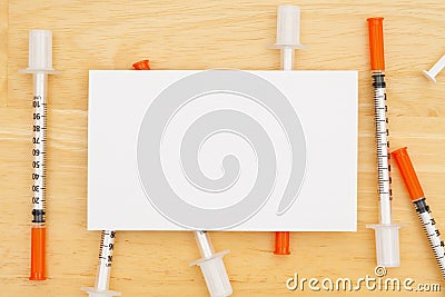 Disposable vaccine needle on desk with a blank note Stock Photo