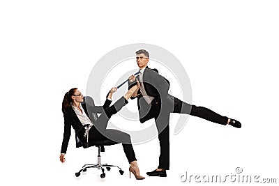 Disputed issues. Two stylish office workers in business suits in action isolated on white background. Art, beauty Stock Photo
