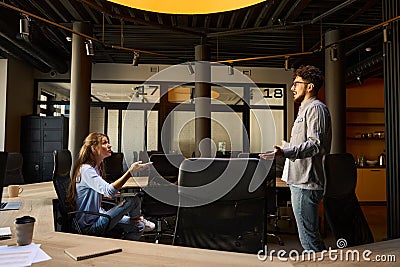 Dissatisfied businessman and irritated businesswoman discussing in office Stock Photo