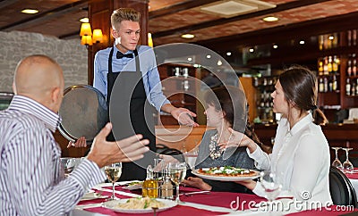 Dissatisfied guests with waiter Stock Photo