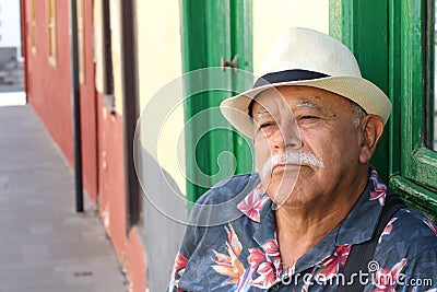 Dissatisfied senior Hispanic man looking with despair Stock Photo