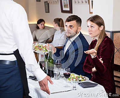 Dissatisfied young couple expressing dissatisfaction with food Stock Photo