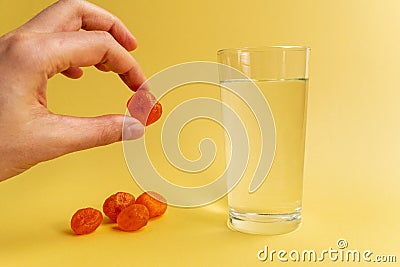 Dissolvable drinks dissolving cubes to add superfoods. On a yellowbackground Stock Photo