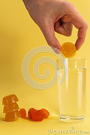 Dissolvable drinks dissolving cubes to add superfoods. On a yellow background. Vertical photo Stock Photo