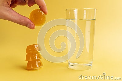 Dissolvable drinks dissolving cubes to add superfoods. On a yellowbackground Stock Photo