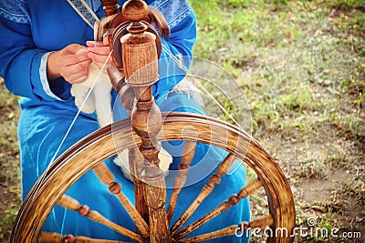 Distaff creates a thread from a spindle. Hand spinning wheel in nature, close-up Stock Photo
