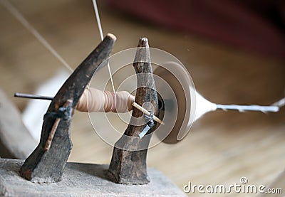 Distaff, spinning yarn on spinning wheel Stock Photo