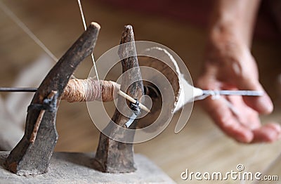 Distaff, spinning yarn on spinning wheel Stock Photo