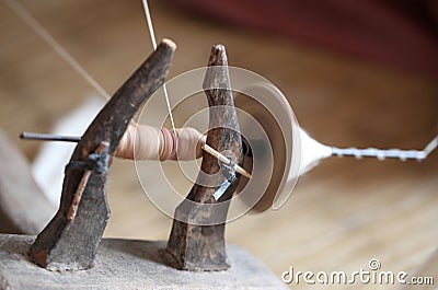 Distaff, spinning yarn on spinning wheel Stock Photo