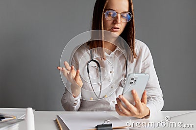 Distance healthcare support. Medical internet. Technology doctor. Health hospital. Healthcare nurse. Serious woman doctor wearing Stock Photo